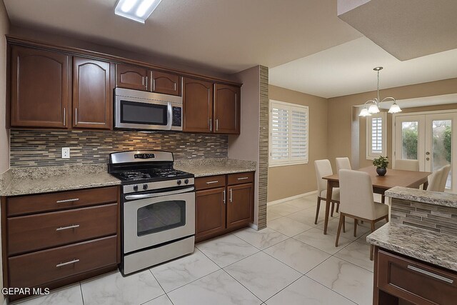 14319 Island Point Dr, El Paso, TX 79938 - kitchen with appliances with stainless steel finishes, tasteful backsplash, pendant lighting, french doors, and light marble finish flooring
