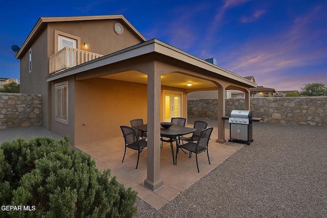 14319 Island Point Dr, El Paso, TX 79938 - patio terrace at dusk featuring a balcony, grilling area, and outdoor dining space