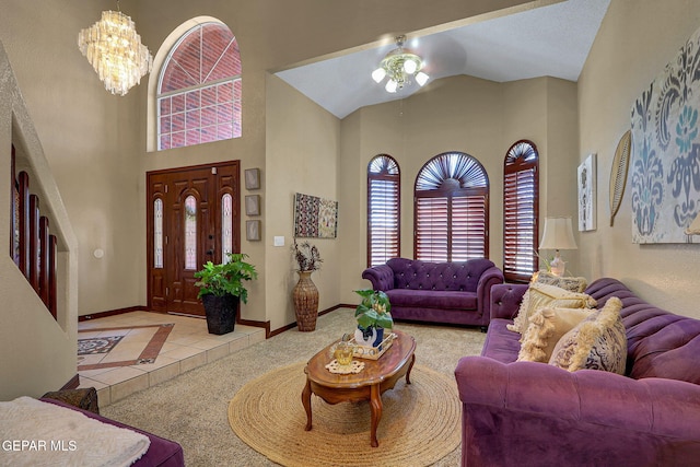 12541 Setting Sun Dr, El Paso, TX 79938 - carpeted living area with baseboards, ceiling fan with notable chandelier, and high vaulted ceiling