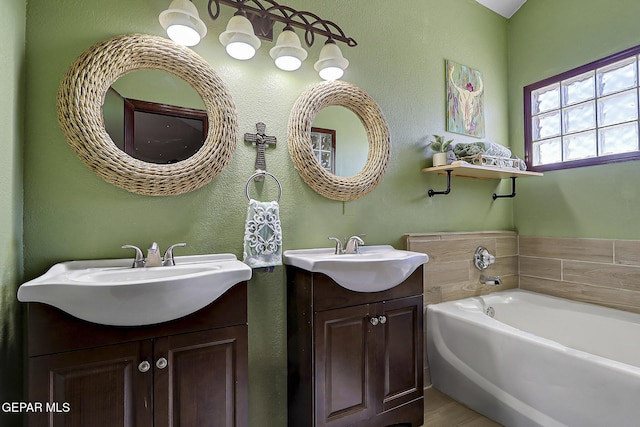 12541 Setting Sun Dr, El Paso, TX 79938 - full bathroom featuring a garden tub, a sink, and two vanities