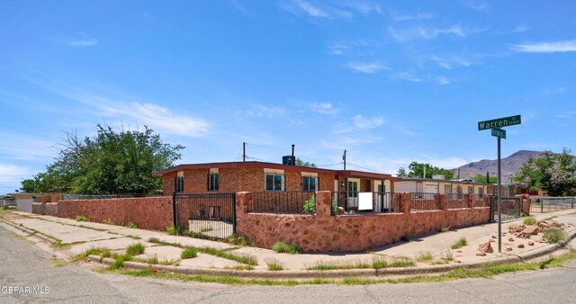 5540 Norwood Ct, El Paso, TX 79924 - view of front of house featuring a fenced front yard, brick siding, and a mountain view