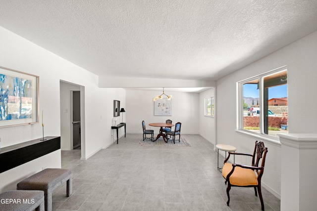 5540 Norwood Ct, El Paso, TX 79924 - dining space featuring a chandelier and a textured ceiling