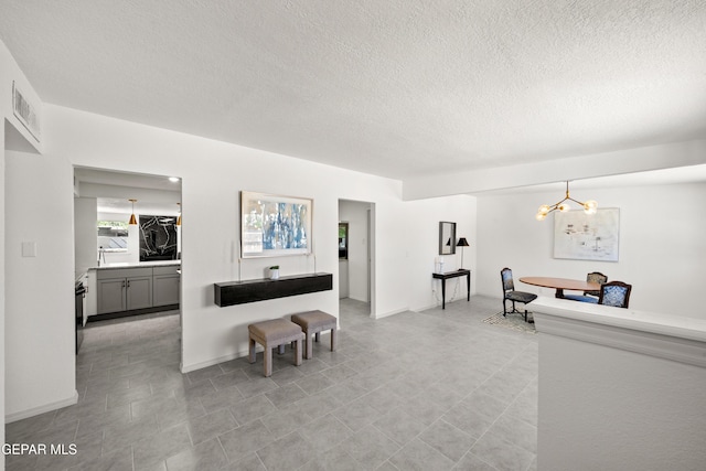 5540 Norwood Ct, El Paso, TX 79924 - living room with a textured ceiling and a chandelier