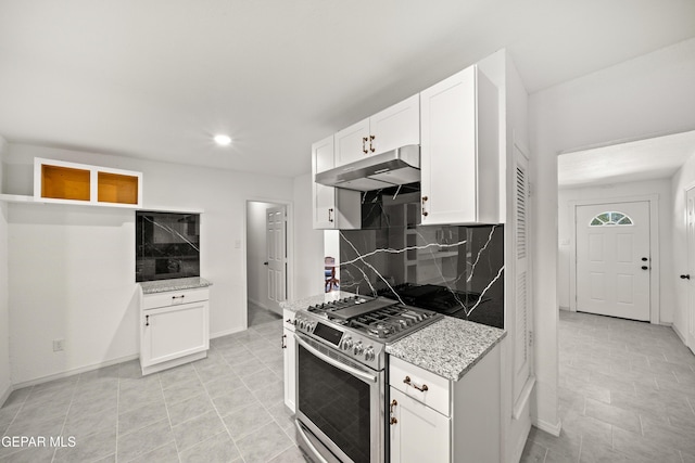 5540 Norwood Ct, El Paso, TX 79924 - kitchen with gas range, under cabinet range hood, decorative backsplash, light stone counters, and white cabinetry