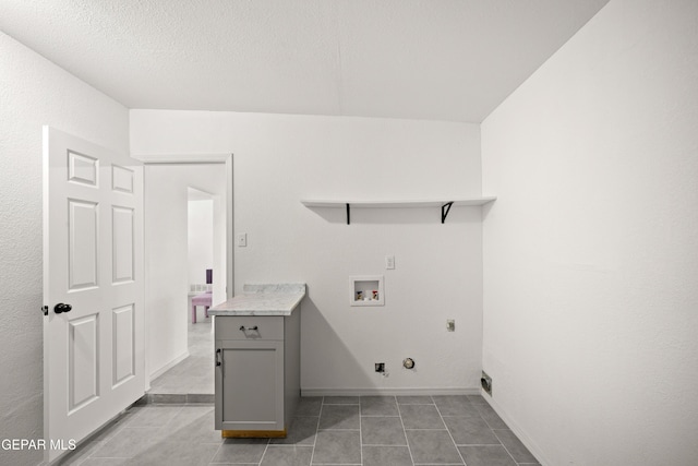 5540 Norwood Ct, El Paso, TX 79924 - laundry area featuring hookup for an electric dryer, washer hookup, gas dryer hookup, light tile patterned floors, and baseboards