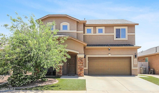 view of front facade with a garage, stucco siding, and concrete driveway