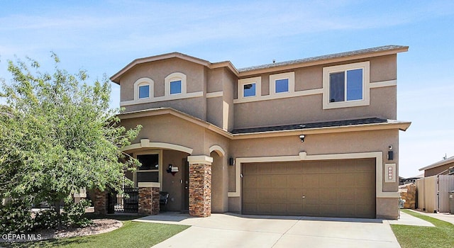 view of front of house with an attached garage, stucco siding, and concrete driveway