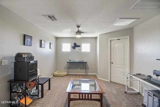 miscellaneous room featuring baseboards, carpet, a ceiling fan, and visible vents