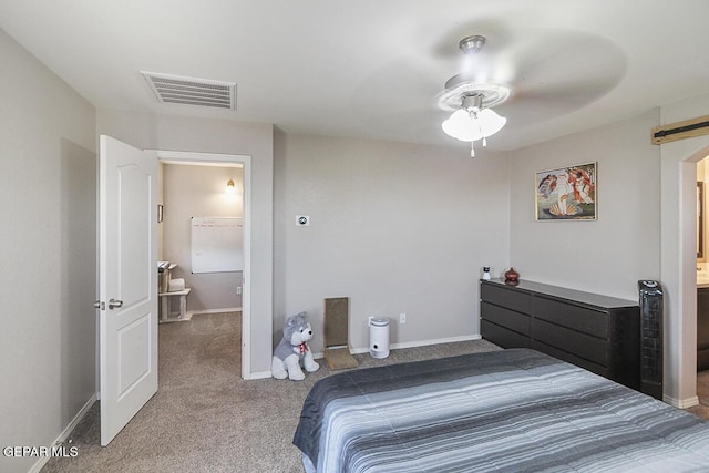 bedroom with visible vents, carpet flooring, baseboards, and ensuite bathroom