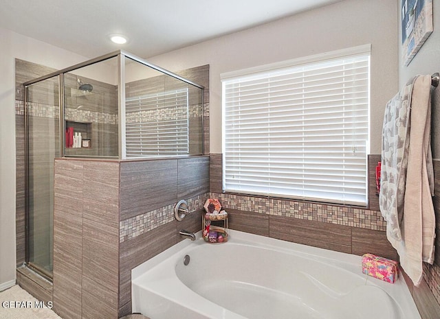 bathroom featuring a bath and a stall shower