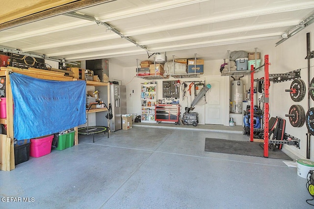 garage with a workshop area and water heater