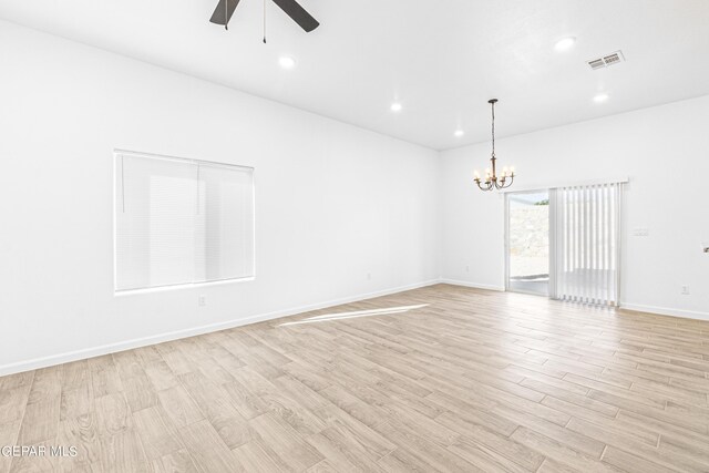 unfurnished room with ceiling fan with notable chandelier, recessed lighting, baseboards, light wood-type flooring, and visible vents
