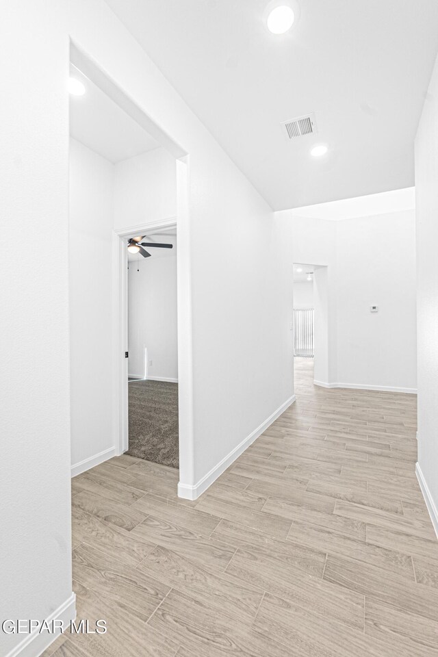 corridor with recessed lighting, baseboards, visible vents, and light wood-style flooring