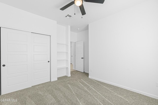 unfurnished bedroom featuring visible vents, a ceiling fan, a closet, baseboards, and carpet flooring