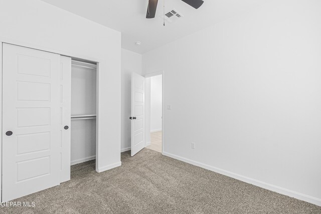 unfurnished bedroom featuring visible vents, a ceiling fan, a closet, baseboards, and carpet flooring