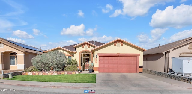 mediterranean / spanish house with a garage, stucco siding, concrete driveway, and a front lawn