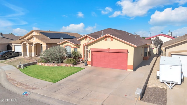 view of front of home featuring a garage, a front yard, stucco siding, concrete driveway, and solar panels