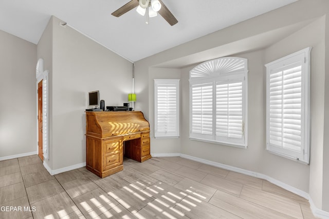 home office with baseboards, a ceiling fan, and vaulted ceiling