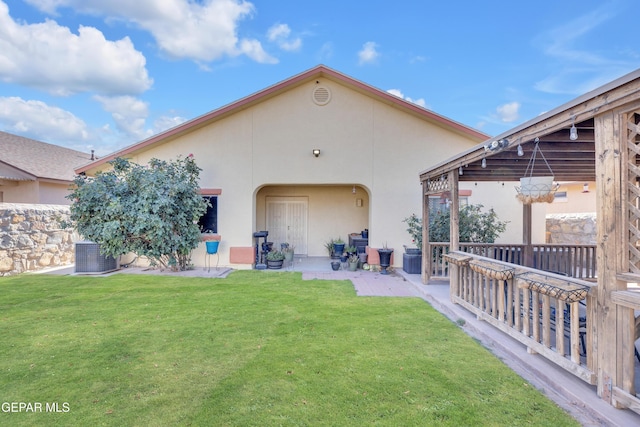 back of house with a lawn, cooling unit, a patio area, and stucco siding