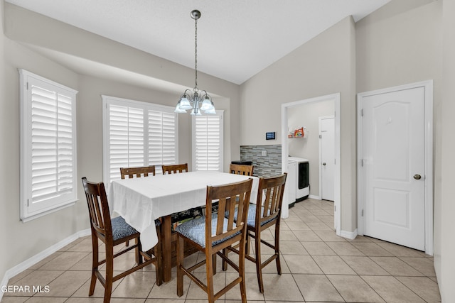 dining room with an inviting chandelier, baseboards, light tile patterned floors, and lofted ceiling