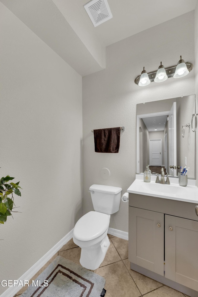 bathroom with visible vents, tile patterned floors, baseboards, vanity, and toilet