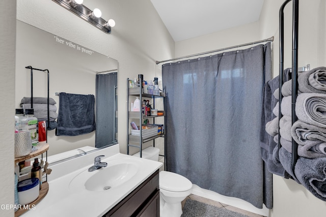 full bathroom featuring vanity, tile patterned flooring, and toilet