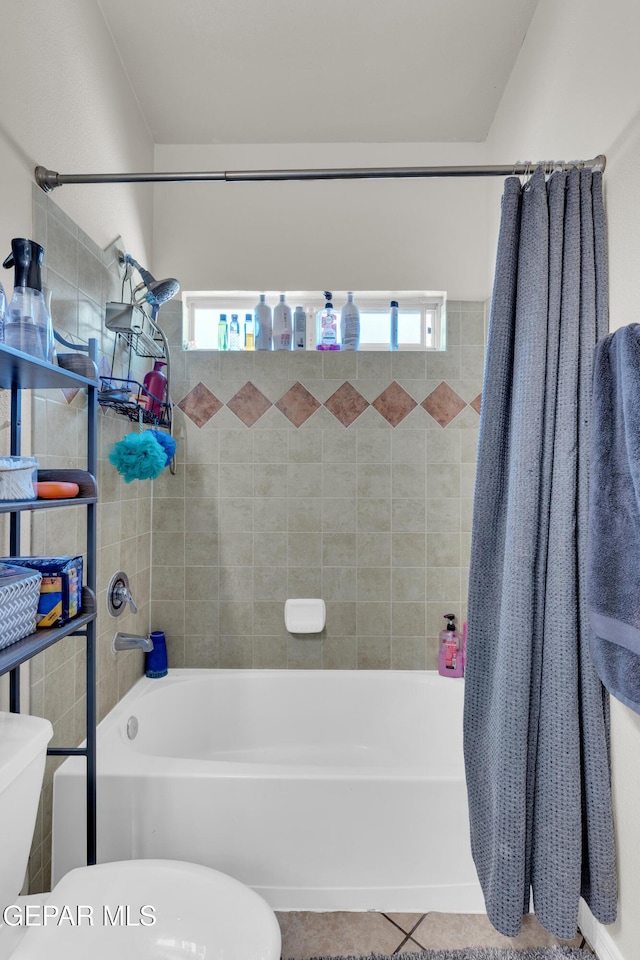 bathroom featuring shower / bathtub combination with curtain, a wealth of natural light, and toilet