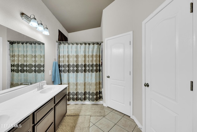 full bathroom featuring a sink, tile patterned floors, double vanity, and a shower with shower curtain
