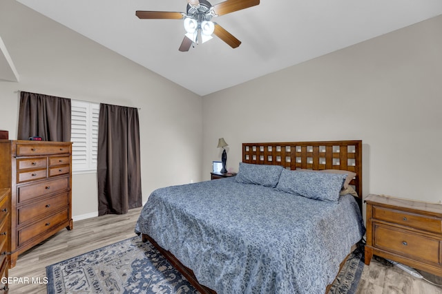 bedroom with baseboards, a ceiling fan, light wood-type flooring, and lofted ceiling