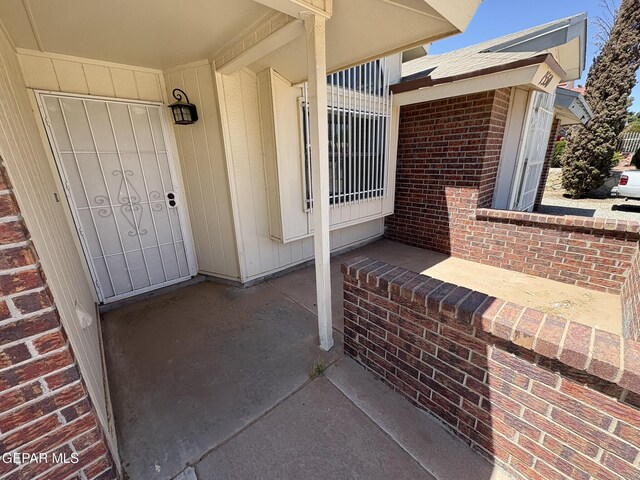view of exterior entry with brick siding