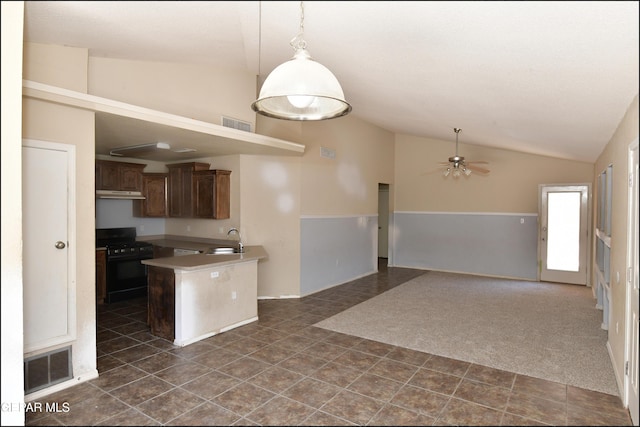 kitchen with a sink, a ceiling fan, lofted ceiling, visible vents, and black gas range