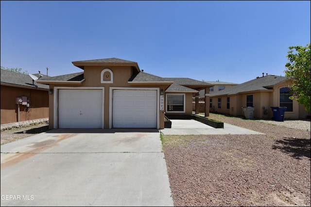 view of front of house with concrete driveway, an attached garage, and stucco siding