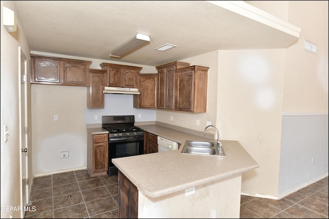 kitchen with a sink, light countertops, a peninsula, under cabinet range hood, and range with gas cooktop