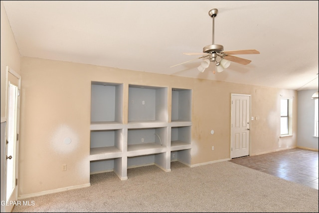 unfurnished living room with baseboards, carpet, ceiling fan, and tile patterned floors