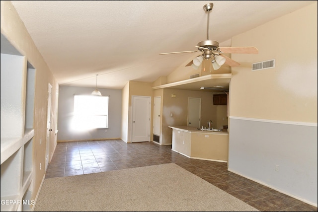 empty room featuring visible vents, a ceiling fan, and dark tile patterned floors