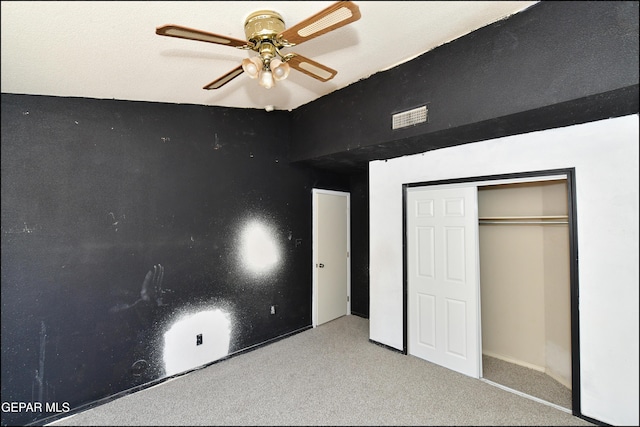 unfurnished bedroom featuring visible vents, carpet flooring, ceiling fan, and a closet