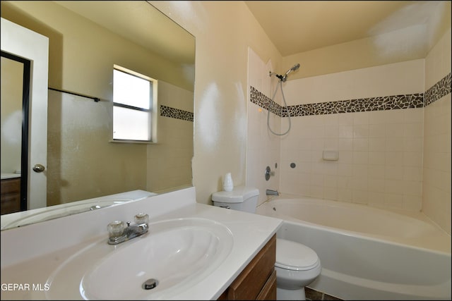 bathroom with toilet,  shower combination, and vanity
