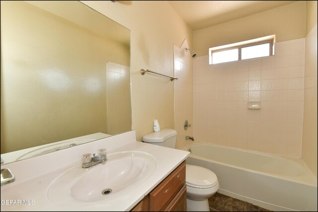 full bathroom featuring toilet, bathing tub / shower combination, and vanity