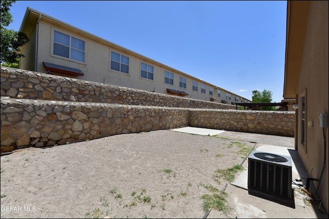 view of yard featuring a patio, a fenced backyard, and central AC