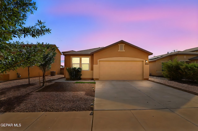 1021 Aerodyne Pl, El Paso, TX 79928 - view of front of house featuring stucco siding, a garage, and driveway