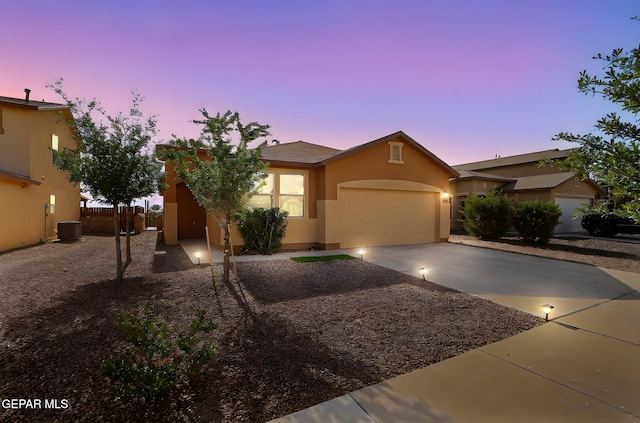 1021 Aerodyne Pl, El Paso, TX 79928 - view of front of home with a garage, concrete driveway, stucco siding, and central AC
