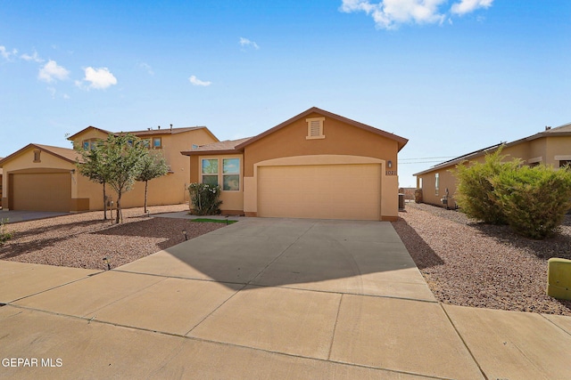 1021 Aerodyne Pl, El Paso, TX 79928 - view of front of home with stucco siding, driveway, and a garage