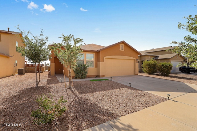 1021 Aerodyne Pl, El Paso, TX 79928 - view of front of home featuring stucco siding, a garage, concrete driveway, fence, and central air condition unit
