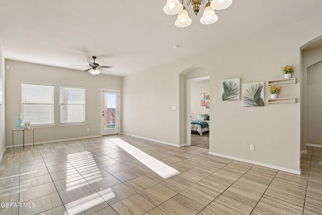 1021 Aerodyne Pl, El Paso, TX 79928 - spare room with arched walkways, a ceiling fan, light tile patterned floors, and a chandelier