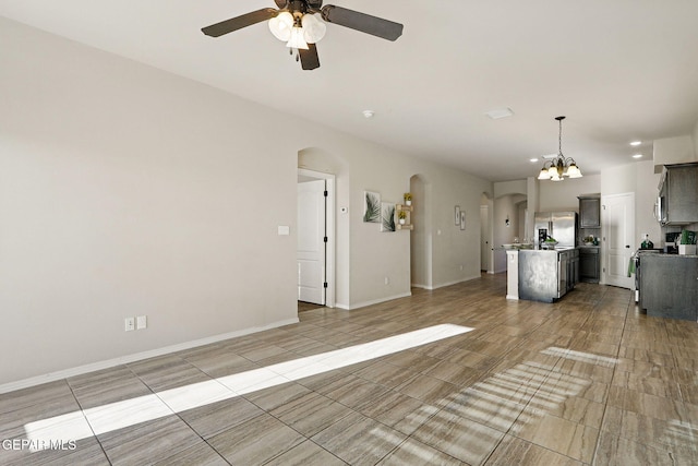 1021 Aerodyne Pl, El Paso, TX 79928 - unfurnished living room featuring arched walkways, ceiling fan, a chandelier, recessed lighting, and baseboards
