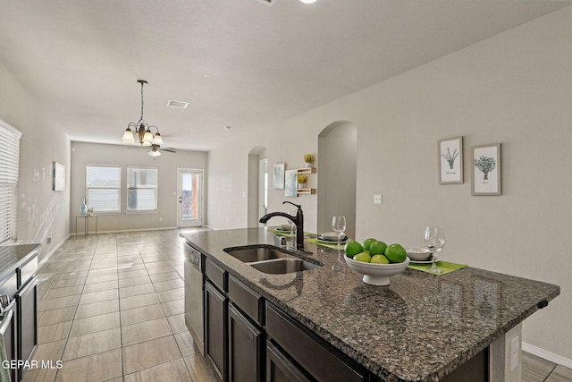 1021 Aerodyne Pl, El Paso, TX 79928 - kitchen featuring a sink, arched walkways, dishwasher, a kitchen island with sink, and open floor plan