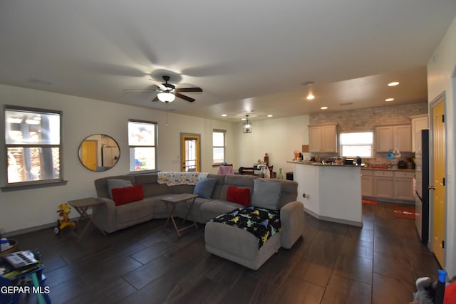 living room with wood tiled floor, ceiling fan, and recessed lighting