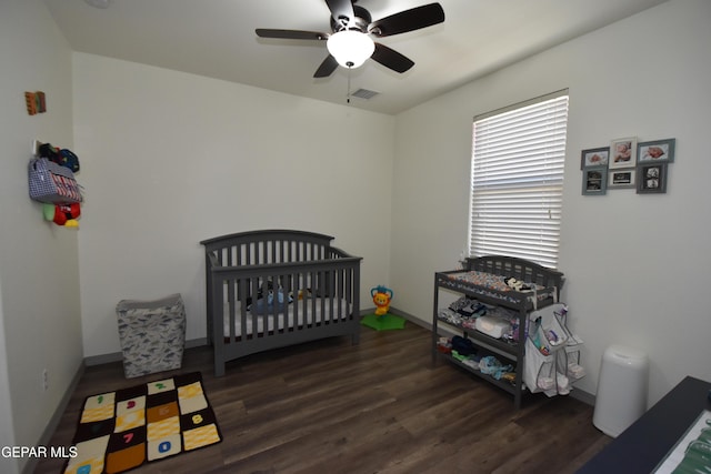 bedroom with a ceiling fan, baseboards, visible vents, and wood finished floors