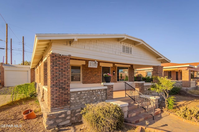 view of front of property with a porch and brick siding