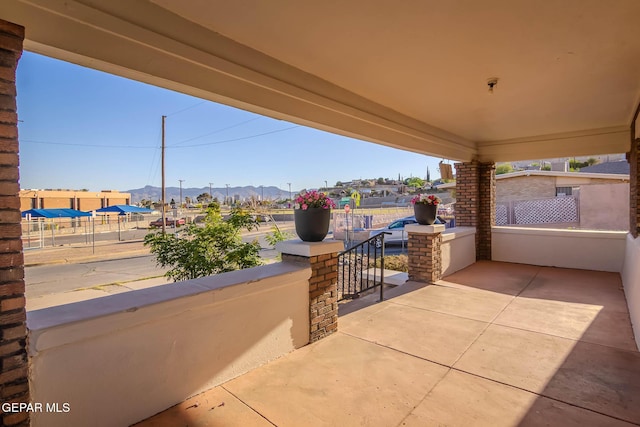view of patio featuring a mountain view and a porch